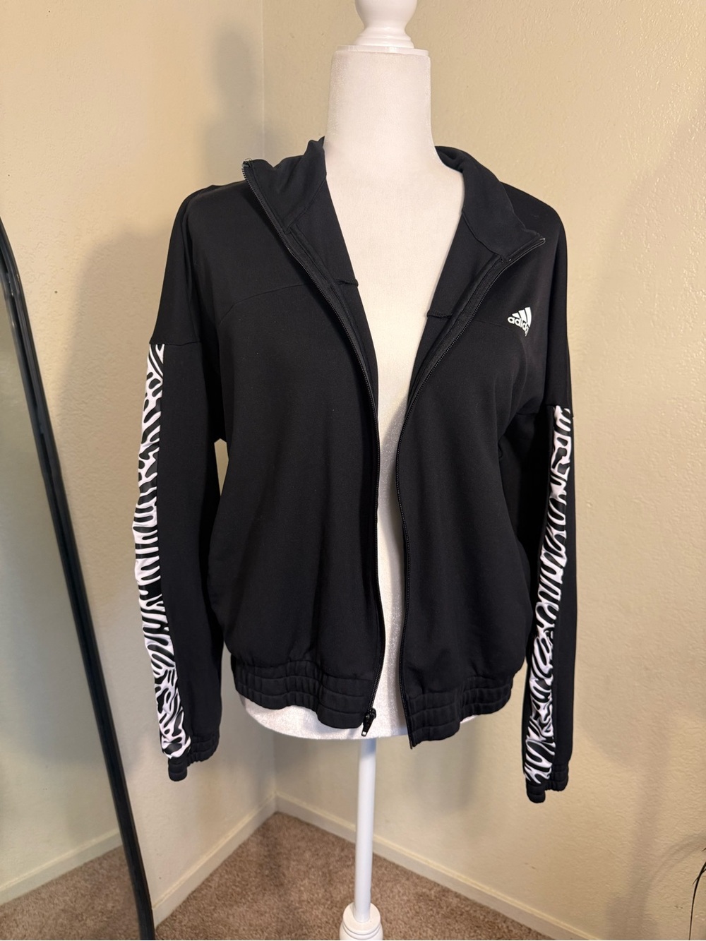 Adidas aerolady black zip up jacket with white zebra stripe pattern on sleeves